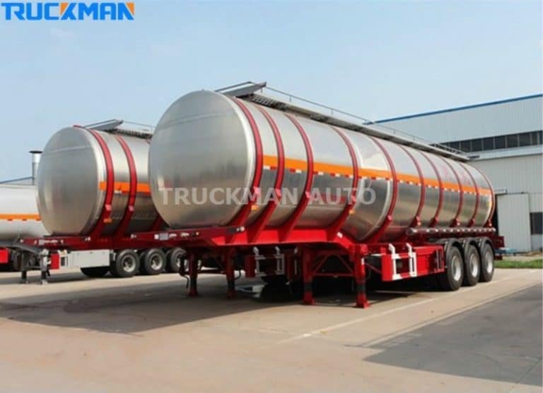 Fila de remolques cisterna de acero inoxidable con rayas rojas en Truckman Auto, diseñados para el transporte seguro de materiales.